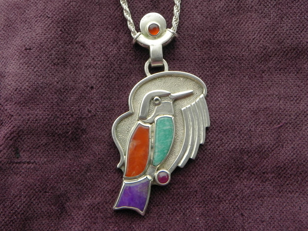 bird with gemstones on silver