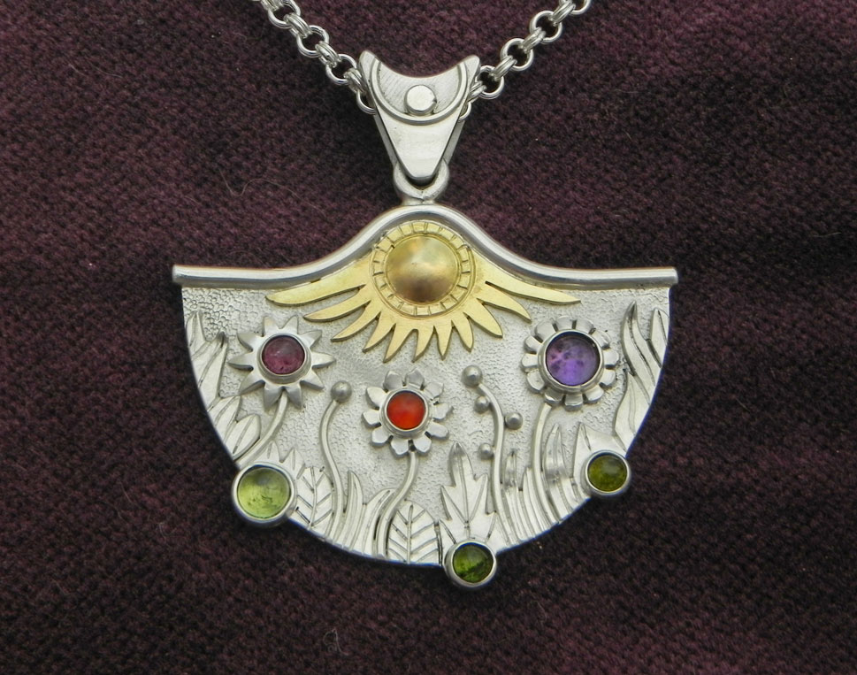 Silverpendant with stylistic flower meadow