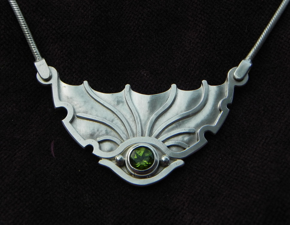 Silverpendant shaped as an eye of a Dragon