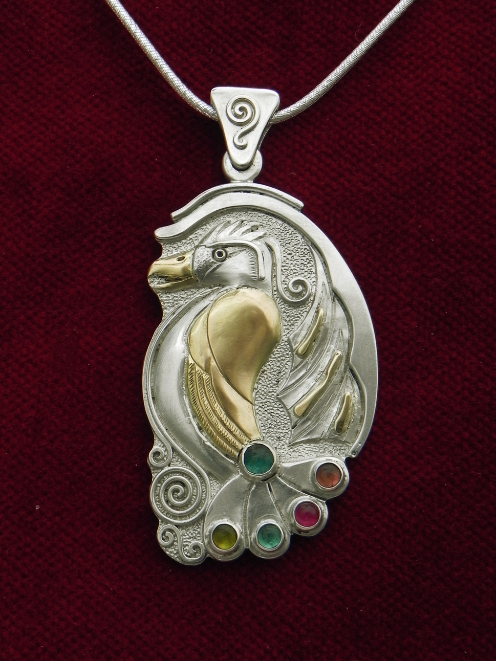 Silverpendant with paradise bird and turmalins 