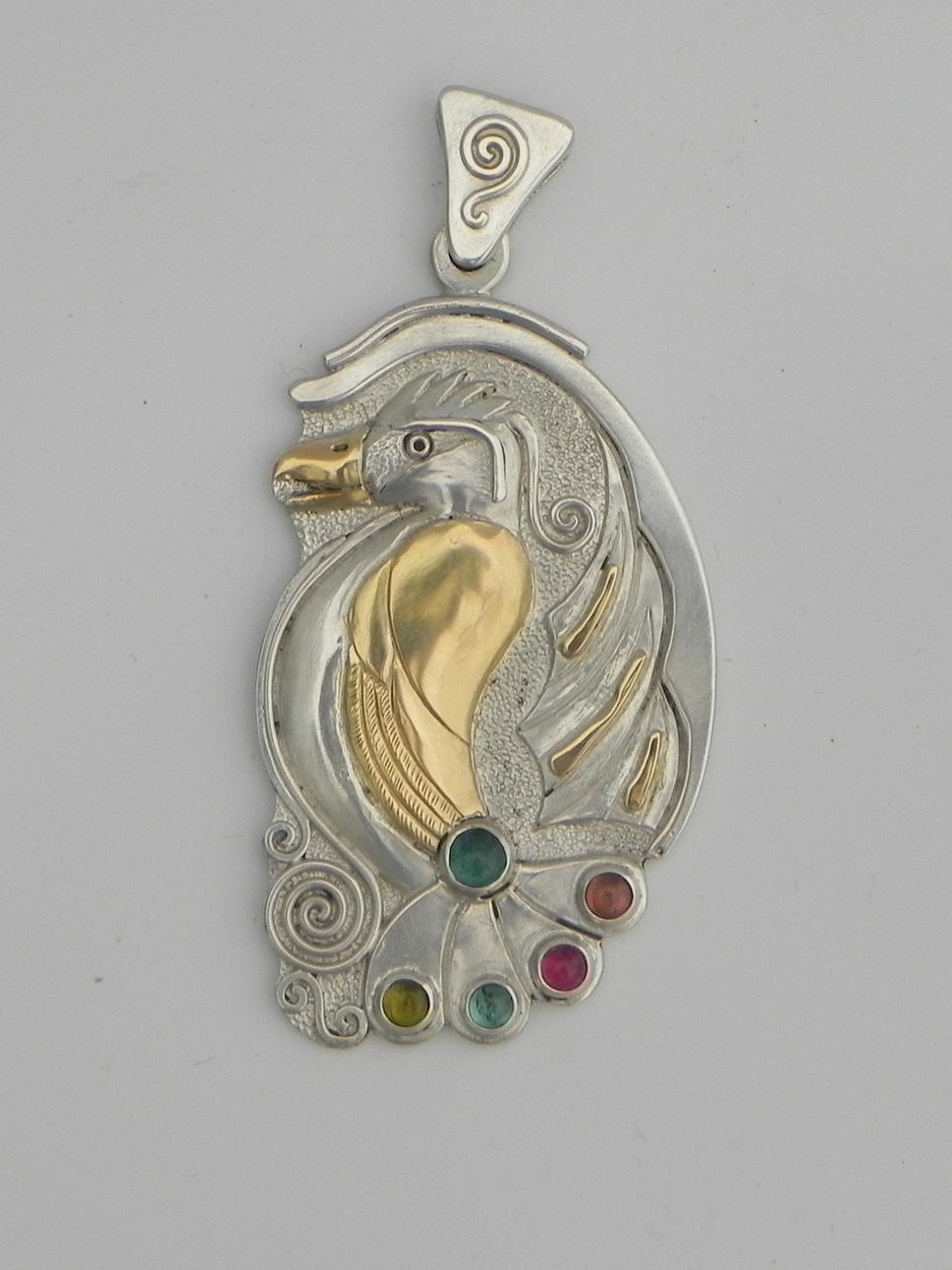 Silverpendant with paradise bird and turmalins 