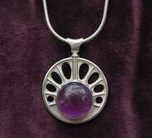 pendant with a big amethyst in a sun shape